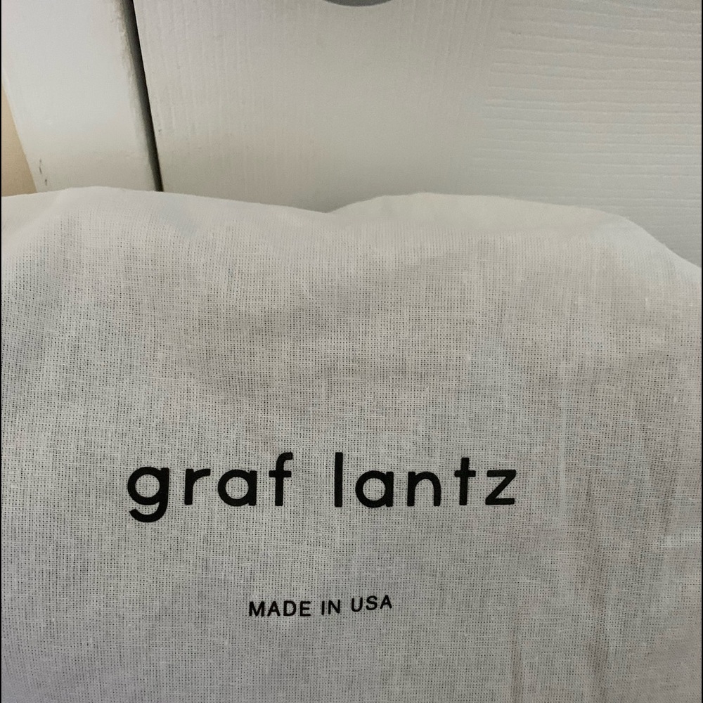 Felt, olive green with  brown adjustable leather straps, zipper top